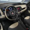 Interior view of a Fiat car showcasing the dashboard, steering wheel, and gear shift, highlighting modern design and features.