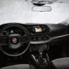 Interior view of a Fiat car showing the dashboard, steering wheel, and control panel.